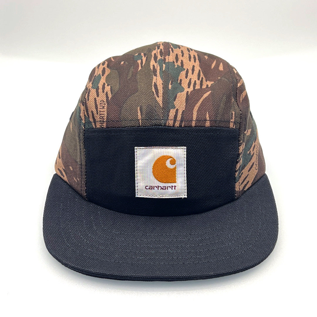 Camo and black Carhartt 5 panel hat with logo on the front, white background.