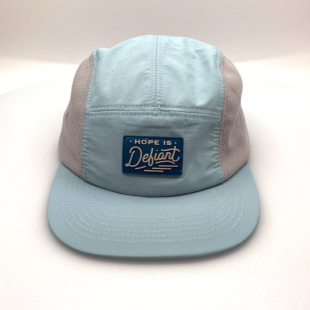 Baby blue Defiant 5 Panel Hat with grey netting on side panels and rubber logo on the front.