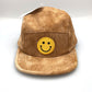 Tan corduroy GuanGu 5 Panel Hat with yellow smiley face on the front panel.