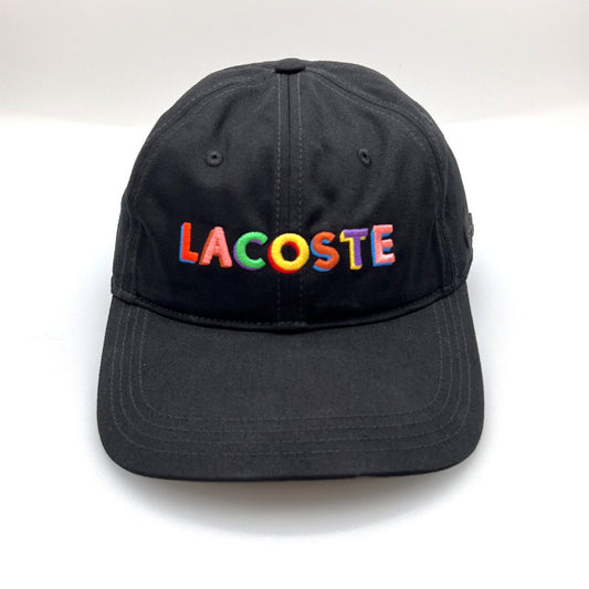 Black Lacoste 6 Panel Hat with multi colored Lacoste letters on the front panel, and white background.