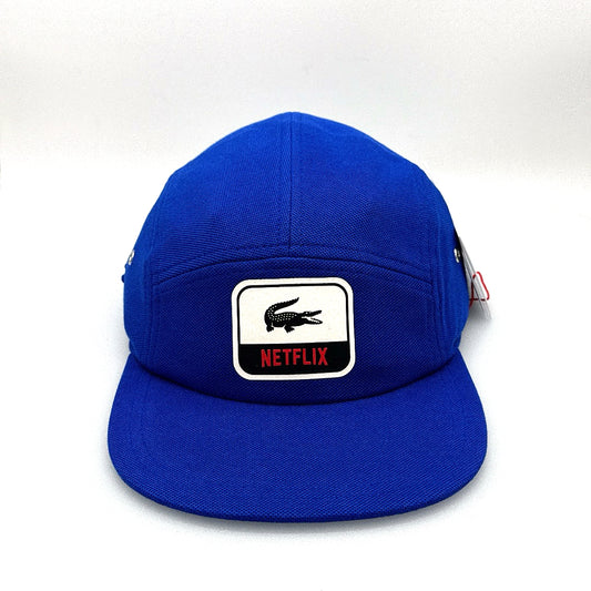 Blue Netflix Lacoste 5 Panel Hat, white alligator along with Netflix logo on the front, with white background.