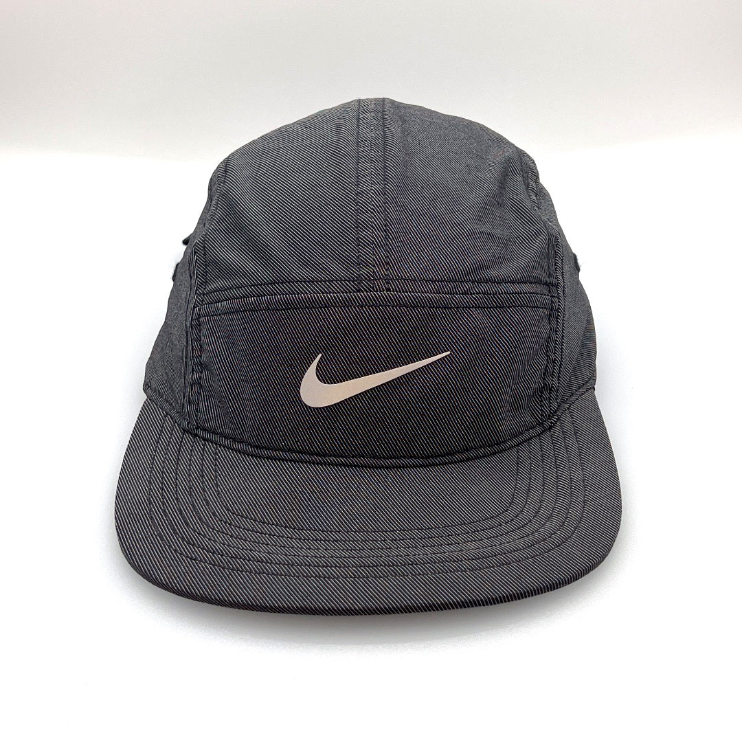 Reflective Nike Black 5 Panel Hat, iconic NIKE swoosh on the front , with white background.