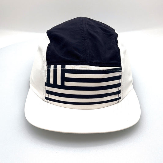 Navy and white North Face 5 Panel Hat, flag print on the front, with a white background.