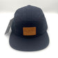 Nylon navy Paper Planes 5 Panel Hat, leather logo on the front, with a white background.