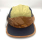Nylon navy, brown, and olive Paper Planes 5 Panel Hat, orange Paper Planes logo on the front, with a white background.