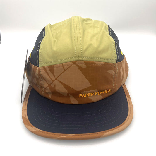 Nylon navy, brown, and olive Paper Planes 5 Panel Hat, orange Paper Planes logo on the front, with a white background.