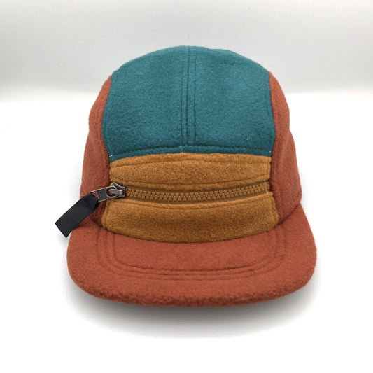 Brown, tan and cyan Patagonia fleece 5 Panel Hat upcycled, zipper on the front, with a white background.