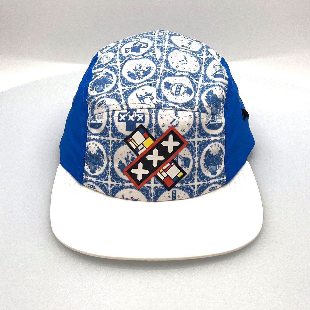 White and blue X Puma 5 Panel Hat, with a white background.