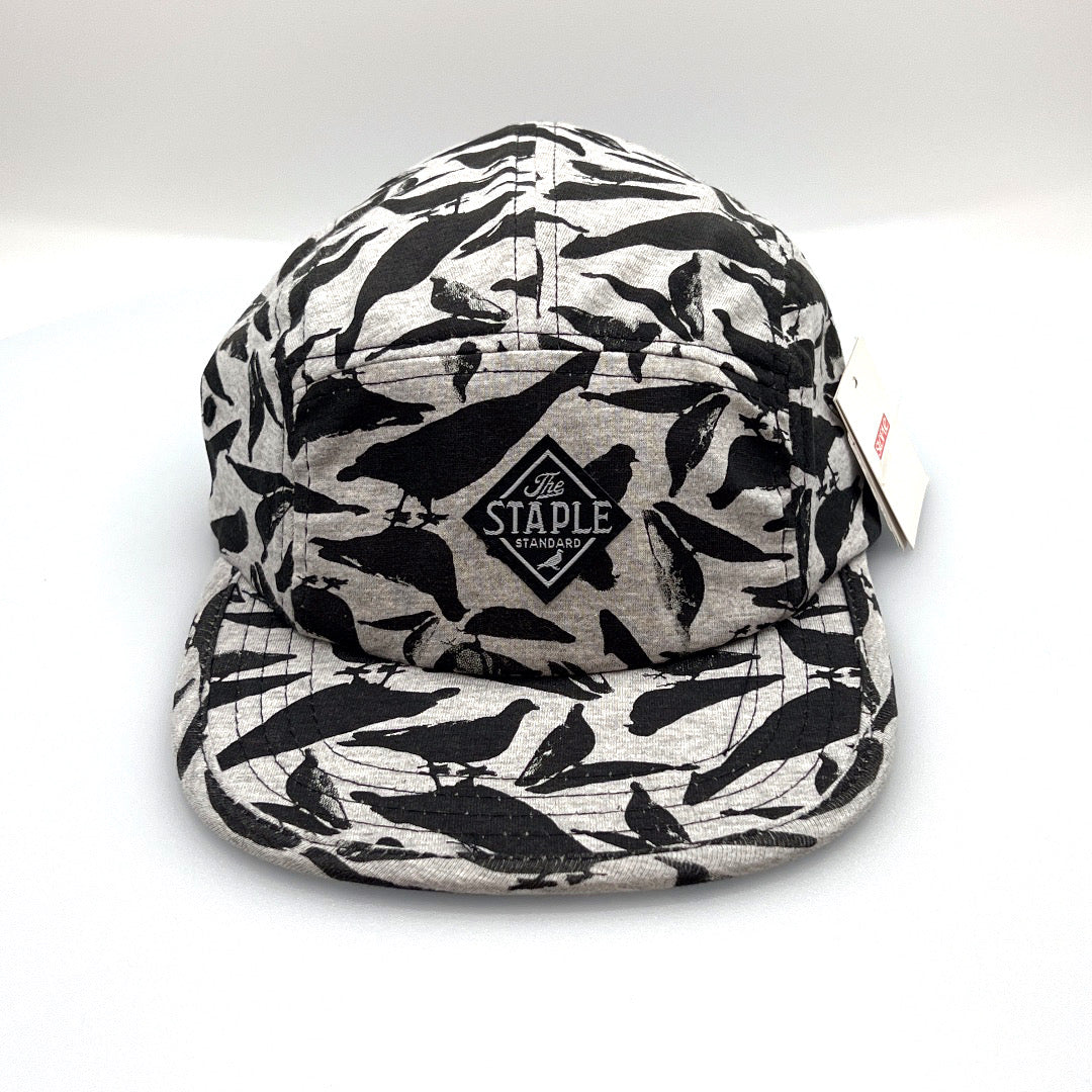 Grey and black Staple Standard Pigeon 5 Panel Hat, with a white background.
