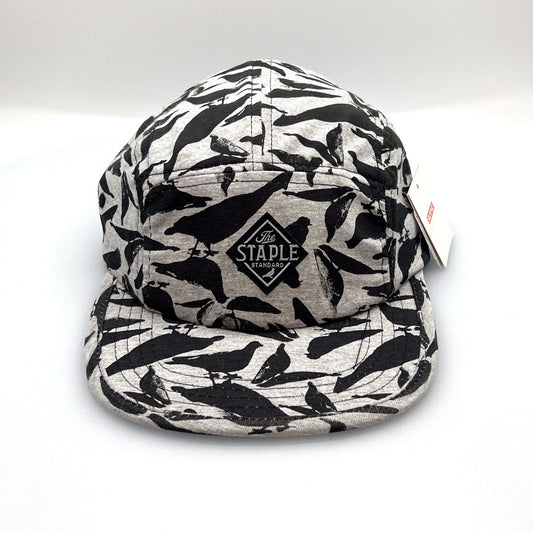 Grey and black Staple Standard Pigeon 5 Panel Hat, with a white background.