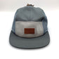 Blue, light grey and dark grey Vans 5 Panel Hat, leather logo on the front, with a white background.