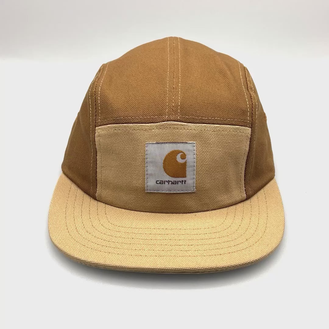 Spinning Tan and brown Carhartt 5 panel hat with logo on the front, white background.
