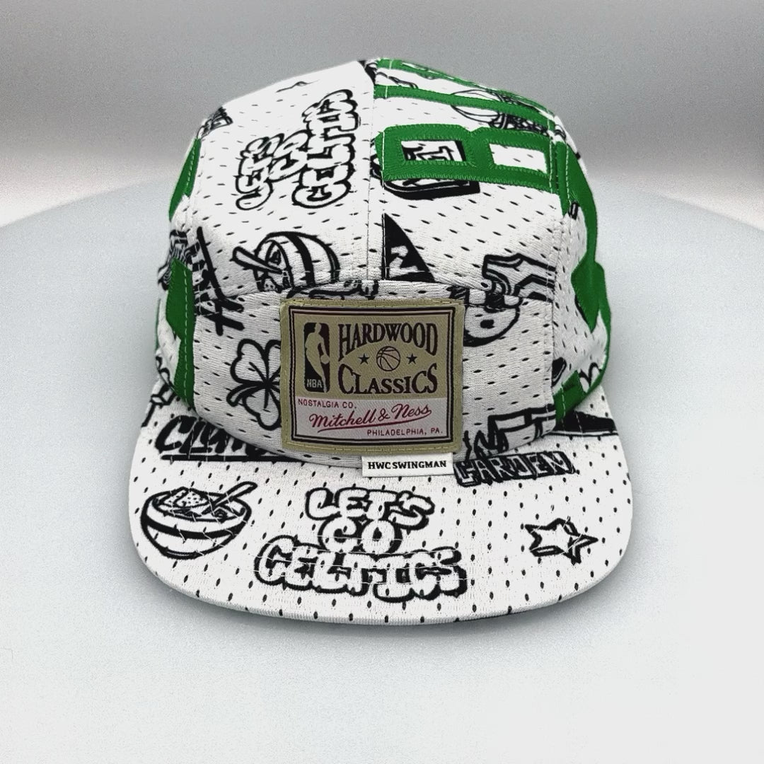 Spinning white and green Mitchell & Ness Larry Bird jersey upcycled to a 5-Panel Hat.