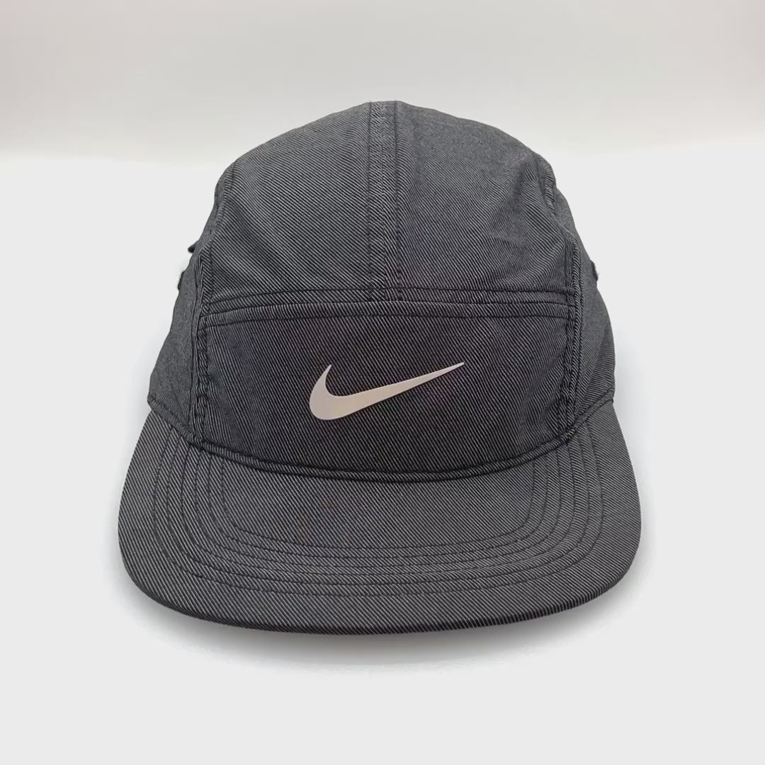 Spinning reflective Nike Black 5 Panel Hat, iconic NIKE swoosh on the front , with white background.