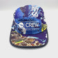 Spinning unique navy, brown and baby blue pattern Paper Planes 5 Panel Hat, CREW Worldwide logo on the front, and a white background.