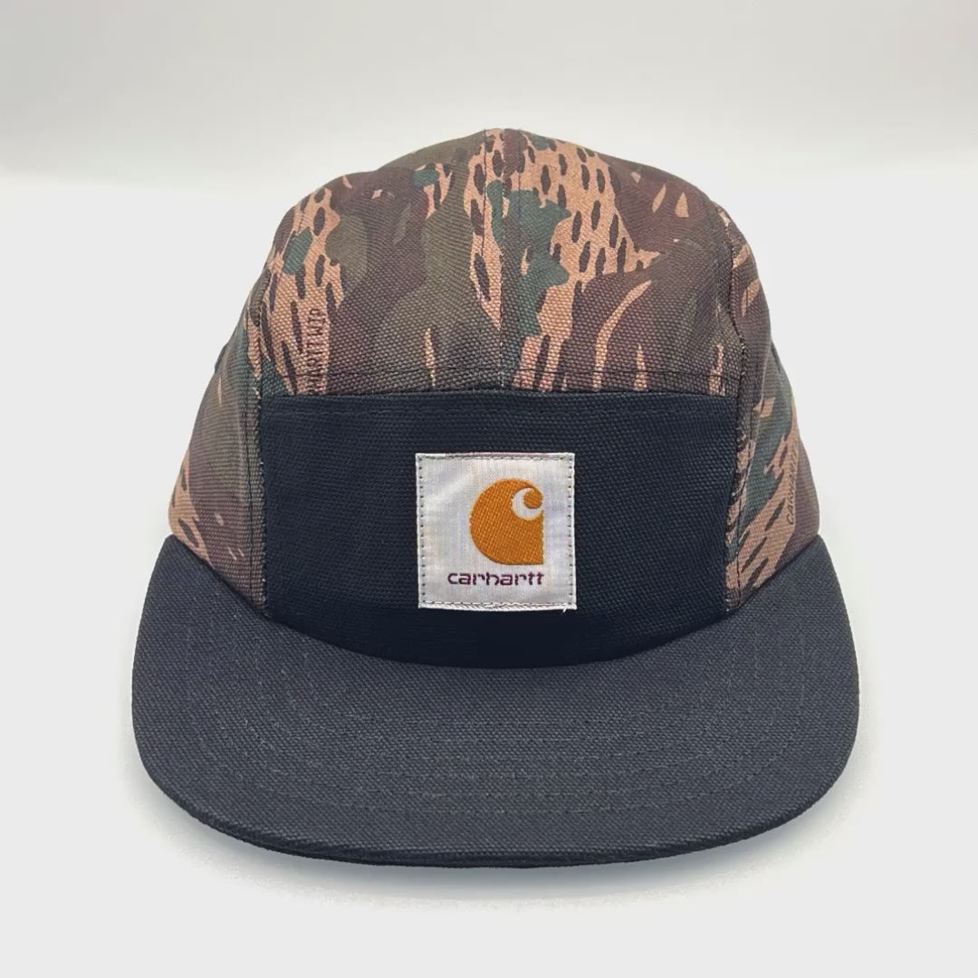 Spinning Camo and black Carhartt 5 panel hat with logo on the front, white background.