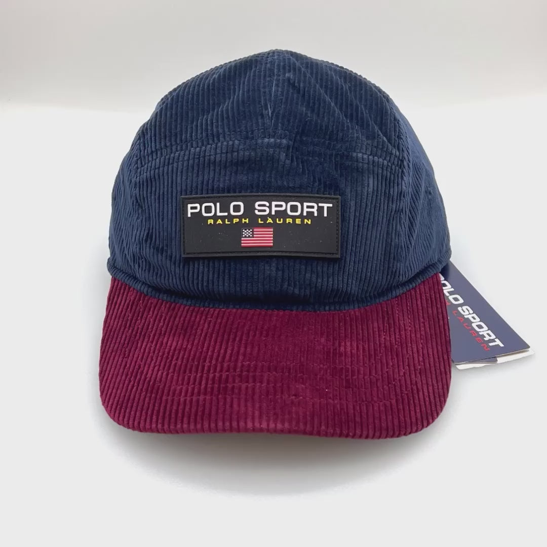Spinning navy and burgundy corduroy Polo Sport 5 Panel Hat, rubber logo on the front, with a white background.
