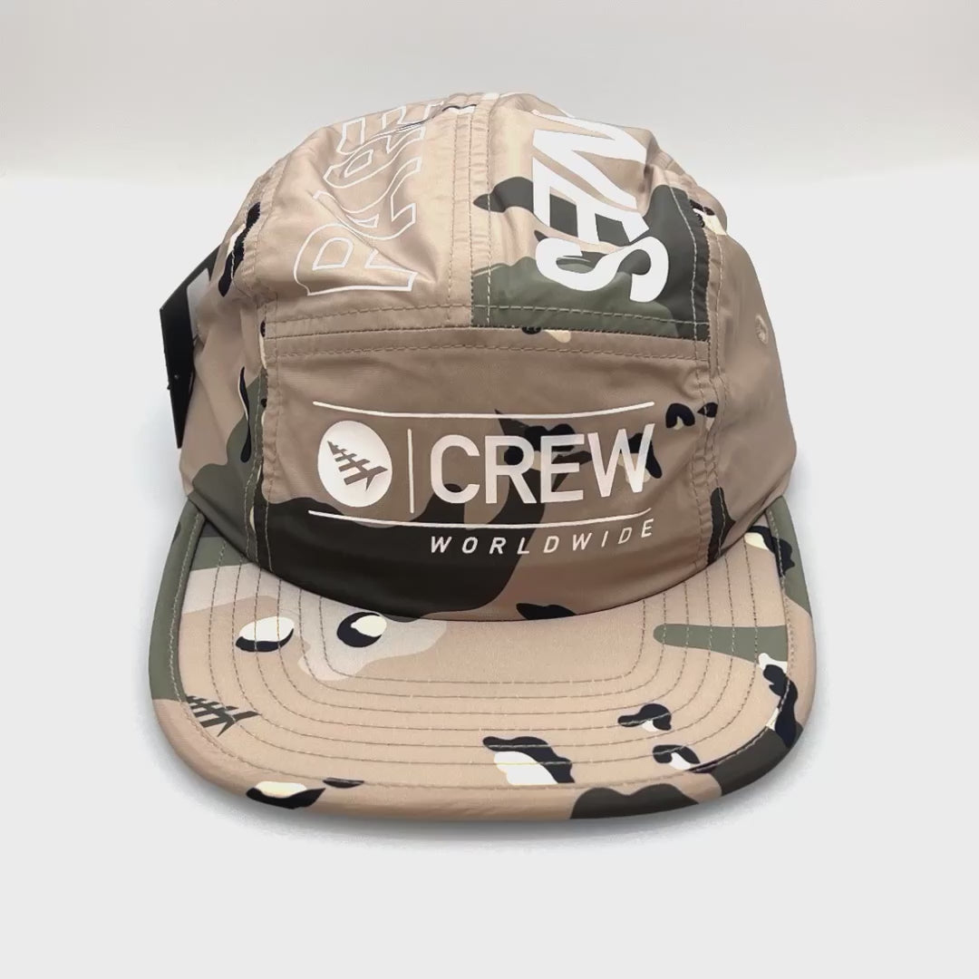 Spinning light brown camo 5 Panel Hat, CREW Worldwide logo on the front, with a white background.
