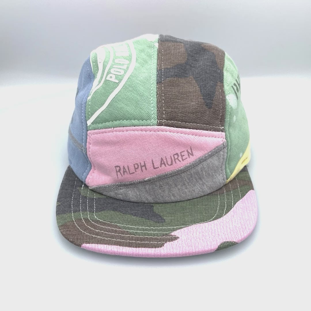Spinning camo, blue, green and pink patchwork Polo 5 Panel Hat upcycled, Ralph Lauren logo on the front, with a white background.