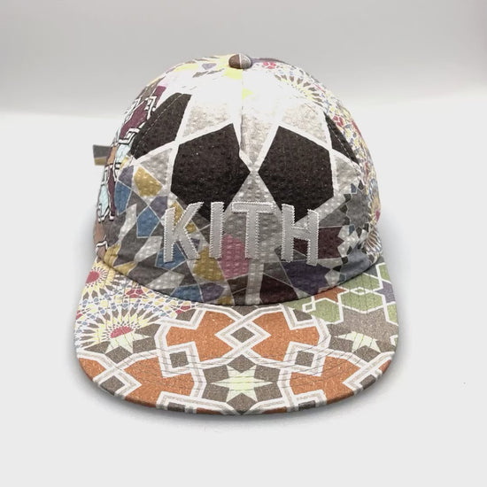 Spinning multi-colored Chic Tile KITH 5 Panel Hat Pattern with white KITH stitching logo on the front.