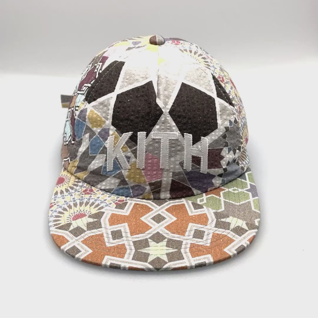 Spinning multi-colored Chic Tile KITH 5 Panel Hat Pattern with white KITH stitching logo on the front.