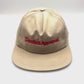 Spinning Khaki Denied Approval 5 Panel Hat with red logo on the front, white background.