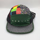 Spinning Mix colored Ciele Berlin 5 Panel Hat with netting on side panels, white background.