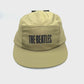 Spinning Army green Beatles 5 Panel Hat with "The Beatles" written on the front panel, white background.