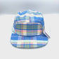Spinning blue, pink, yellow and white plaid pattern Lacoste 5 Panel Hat, with white background.