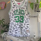 The making of a white and green Mitchell & Ness Larry Bird jersey upcycled to a 5-Panel Hat.