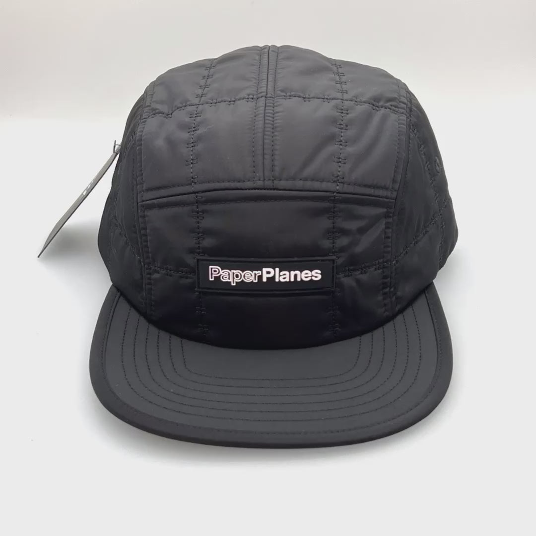 Spinning stitch black Paper Planes 5 Panel Hat, with a white background.