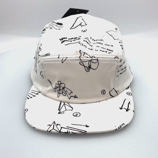 Spinnig white and black sketch Paper Planes 5 Panel Hat, with a white background.